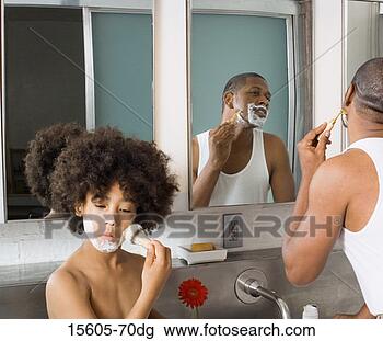 Stock Photo - son applying shaving 
cream while father 
shaves. fotosearch 
- search stock 
photos, pictures, 
images, and photo 
clipart