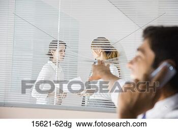 Stock Photo - businessman peeking 
through blinds 
at businesswomen. 
fotosearch - search 
stock photos, 
pictures, images, 
and photo clipart