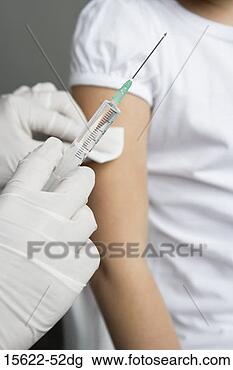 Stock Photo - medical professional 
giving vaccination 
shot. fotosearch 
- search stock 
photos, pictures, 
images, and photo 
clipart