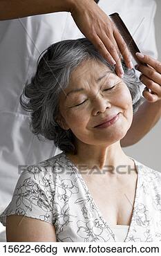 Stock Photo - person combing 
woman's hair. 
fotosearch - search 
stock photos, 
pictures, images, 
and photo clipart