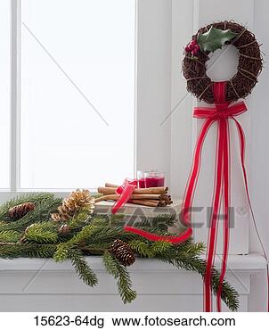 Stock Photo - christmas wreath 
and boughs on 
window sill. fotosearch 
- search stock 
photos, pictures, 
images, and photo 
clipart