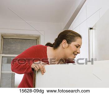 Stock Photo - woman looking 
in refrigerator. 
fotosearch - search 
stock photos, 
pictures, images, 
and photo clipart