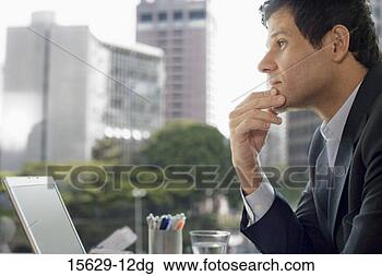 Stock Photo - businessman thinking 
with laptop. fotosearch 
- search stock 
photos, pictures, 
images, and photo 
clipart