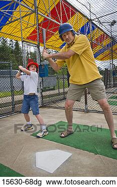 Stock Photo - father and daughter 
in batting cage. 
fotosearch - search 
stock photos, 
pictures, images, 
and photo clipart