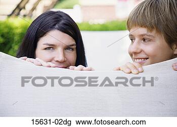 Stock Photo - women peeking 
and smiling. fotosearch 
- search stock 
photos, pictures, 
images, and photo 
clipart