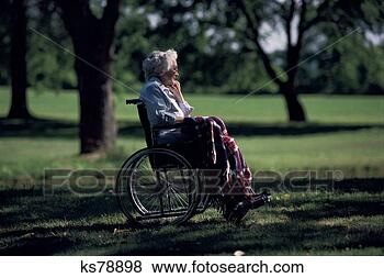 Stock Photo - woman in wheelchair 
outdoors. fotosearch 
- search stock 
photos, pictures, 
images, and photo 
clipart
