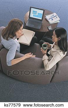Stock Photograph - women talking 
with laptop, shot 
from above. fotosearch 
- search stock 
photos, pictures, 
images, and photo 
clipart