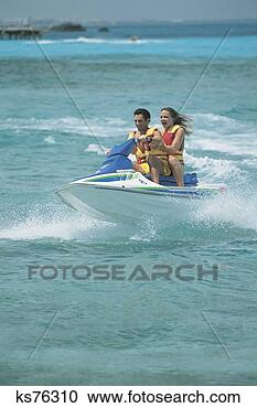 Stock Photography - couple riding 
jet ski. fotosearch 
- search stock 
photos, pictures, 
images, and photo 
clipart