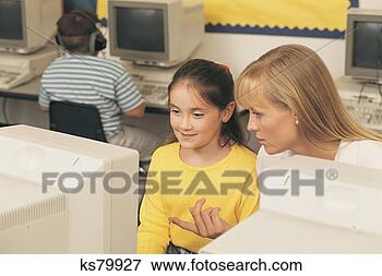 Picture - teacher helping 
student with computer. 
fotosearch - search 
stock photos, 
pictures, images, 
and photo clipart