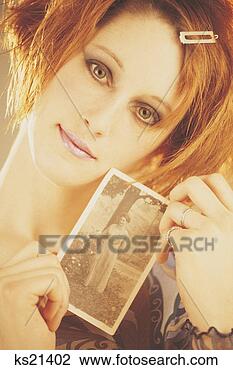Stock Photo - woman holding 
an old photograph, 
portrait. fotosearch 
- search stock 
photos, pictures, 
images, and photo 
clipart