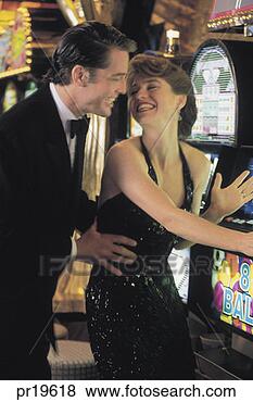 Stock Photo - couple gambling 
on the slot machine 
in casino. fotosearch 
- search stock 
photos, pictures, 
images, and photo 
clipart