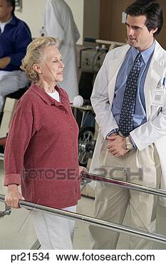 Stock Photo - doctor and patient 
doing physical 
therapy. fotosearch 
- search stock 
photos, pictures, 
images, and photo 
clipart