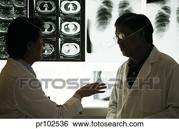 Stock Photo - doctors discussing 
in x-ray room; 
silhouettes. fotosearch 
- search stock 
photos, pictures, 
images, and photo 
clipart