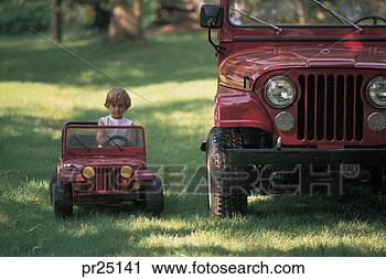 Stock Photography - little boy in 
hotwheels jeep 
next to a real 
jeep. fotosearch 
- search stock 
photos, pictures, 
images, and photo 
clipart