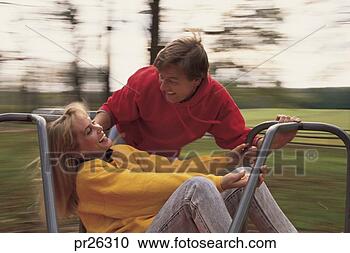 Stock Photography - man and woman 
on merry-go-round. 
fotosearch - search 
stock photos, 
pictures, images, 
and photo clipart