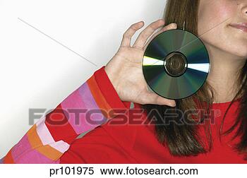 Stock Image - teenager holding 
cd. fotosearch 
- search stock 
photos, pictures, 
images, and photo 
clipart