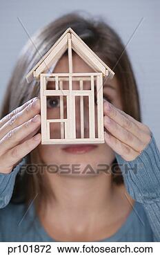 Stock Photo - woman holding 
model house. fotosearch 
- search stock 
photos, pictures, 
images, and photo 
clipart