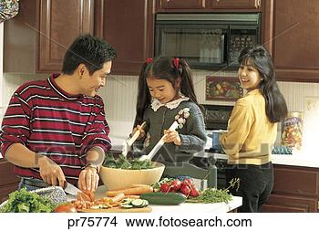 Stock Photo - family in kitchen 
preparing food. 
fotosearch - search 
stock photos, 
pictures, images, 
and photo clipart
