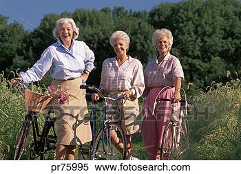 Stock Image - three older women 
with bicycles 
outside. fotosearch 
- search stock 
photos, pictures, 
images, and photo 
clipart