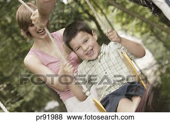 Stock Photo - boy being pushed 
on swing by parents. 
fotosearch - search 
stock photos, 
pictures, images, 
and photo clipart