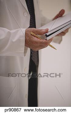 Picture - doctor holding 
patient chart. 
fotosearch - search 
stock photos, 
pictures, images, 
and photo clipart