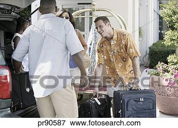 Picture - hotel employee 
helping family 
unload luggage. 
fotosearch - search 
stock photos, 
pictures, images, 
and photo clipart