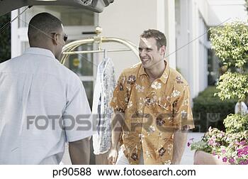 Stock Photo - hotel employee 
helping man unload 
luggage. fotosearch 
- search stock 
photos, pictures, 
images, and photo 
clipart