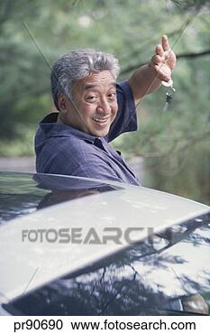 Stock Photography - man getting out 
of car holding 
car keys, portrait. 
fotosearch - search 
stock photos, 
pictures, images, 
and photo clipart