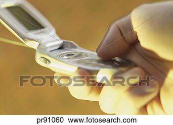 Stock Photography - man holding cell 
phone. fotosearch 
- search stock 
photos, pictures, 
images, and photo 
clipart