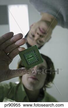 Stock Image - man holding computer 
chip. fotosearch 
- search stock 
photos, pictures, 
images, and photo 
clipart