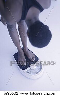 Stock Photo - woman weighing 
herself. fotosearch 
- search stock 
photos, pictures, 
images, and photo 
clipart