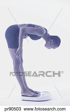 Stock Photo - woman weighing 
herself. fotosearch 
- search stock 
photos, pictures, 
images, and photo 
clipart