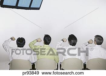 Stock Photograph - men looking at 
flight information 
display screen 
and their watches. 
fotosearch - search 
stock photos, 
pictures, images, 
and photo clipart