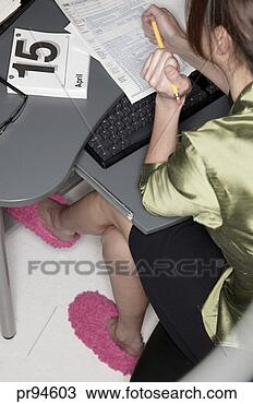 Stock Photo - woman completing 
tax form. fotosearch 
- search stock 
photos, pictures, 
images, and photo 
clipart