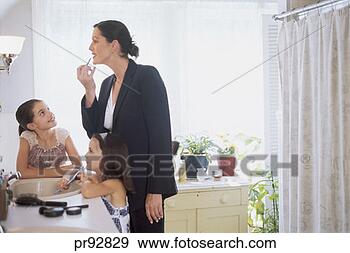 Stock Photograph - woman with daughters 
applying makeup 
in bathroom. fotosearch 
- search stock 
photos, pictures, 
images, and photo 
clipart