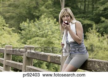 Stock Photo - woman in exercise 
gear eating apple. 
fotosearch - search 
stock photos, 
pictures, images, 
and photo clipart