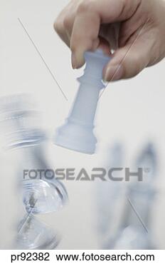 Stock Photo - woman moving chess 
piece. fotosearch 
- search stock 
photos, pictures, 
images, and photo 
clipart