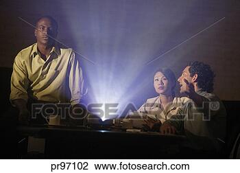 Stock Photo - business team 
watching slide 
presentation. 
fotosearch - search 
stock photos, 
pictures, images, 
and photo clipart