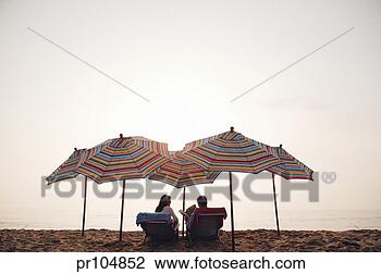 Stock Photo - couple on beach 
under umbrellas. 
fotosearch - search 
stock photos, 
pictures, images, 
and photo clipart