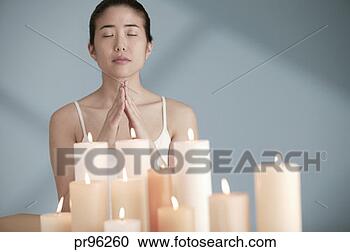 Stock Photography - woman with candles 
in front of her. 
fotosearch - search 
stock photos, 
pictures, images, 
and photo clipart