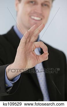 Stock Photograph - businessman indicating 
success. fotosearch 
- search stock 
photos, pictures, 
images, and photo 
clipart