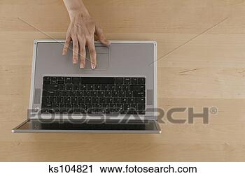 Stock Photography - hand touching 
laptop computer. 
fotosearch - search 
stock photos, 
pictures, images, 
and photo clipart