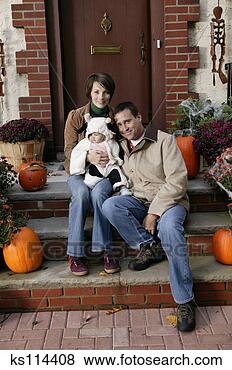 Stock Photo - parents holding 
baby dressed in 
cow costume, portrait. 
fotosearch - search 
stock photos, 
pictures, images, 
and photo clipart