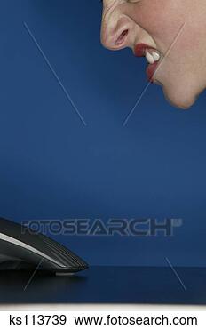 Stock Photograph - unhappy woman 
talking into a 
speaker. fotosearch 
- search stock 
photos, pictures, 
images, and photo 
clipart