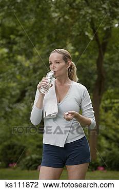 Stock Photo - woman drinking 
water after exercising, 
portrait. fotosearch 
- search stock 
photos, pictures, 
images, and photo 
clipart