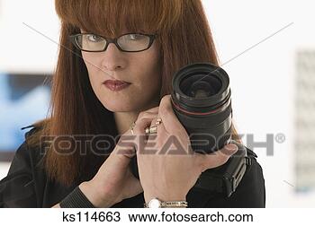 Stock Photo - woman holding 
camera, portrait. 
fotosearch - search 
stock photos, 
pictures, images, 
and photo clipart