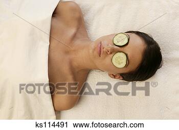 Stock Photography - woman at a spa 
with cucumber 
slices on her 
eyes. fotosearch 
- search stock 
photos, pictures, 
images, and photo 
clipart