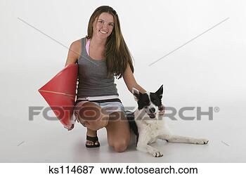 Picture - woman with surfboard 
petting dog, portrait. 
fotosearch - search 
stock photos, 
pictures, images, 
and photo clipart