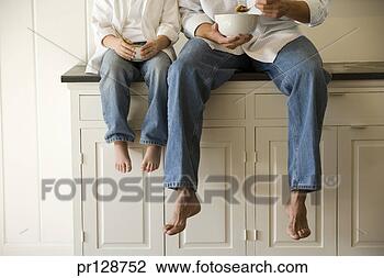 Stock Photo - father and son 
sitting on kitchen 
counter eating 
breakfast. fotosearch 
- search stock 
photos, pictures, 
images, and photo 
clipart