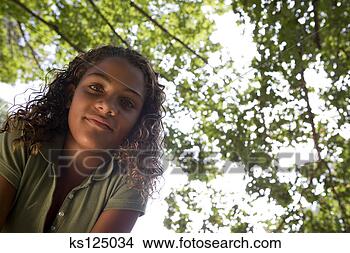 Stock Photo - girl beneath verdant 
tree branches. 
fotosearch - search 
stock photos, 
pictures, images, 
and photo clipart
